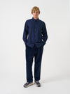 Front view of a model wearing the Navy Prince Chambray Daybrook Shirt in a plain studio setting. The model faces forward, highlighting the classic collar, chest pocket, button placket, and navy blue chambray texture.