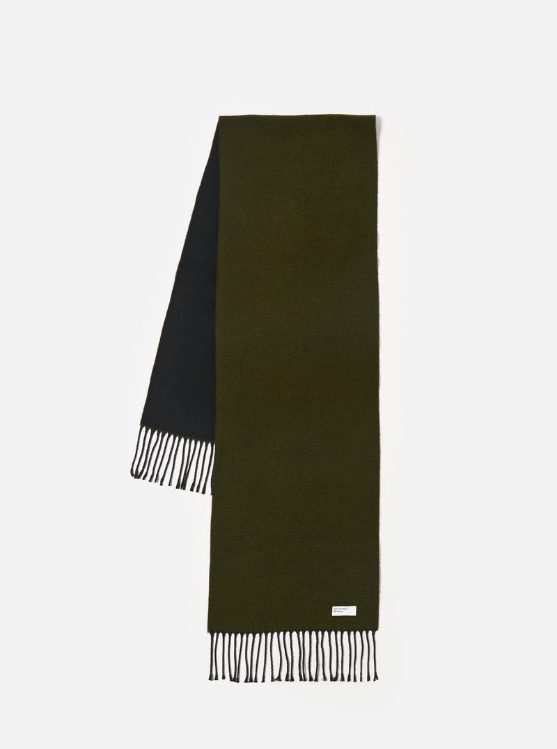 Front view of the Green/Black Double Sided Scarf laid flat on a neutral background. The image highlights the two-tone color combination of dark green and black, showing the knit texture, fringe edge detailing, and woven finish.
