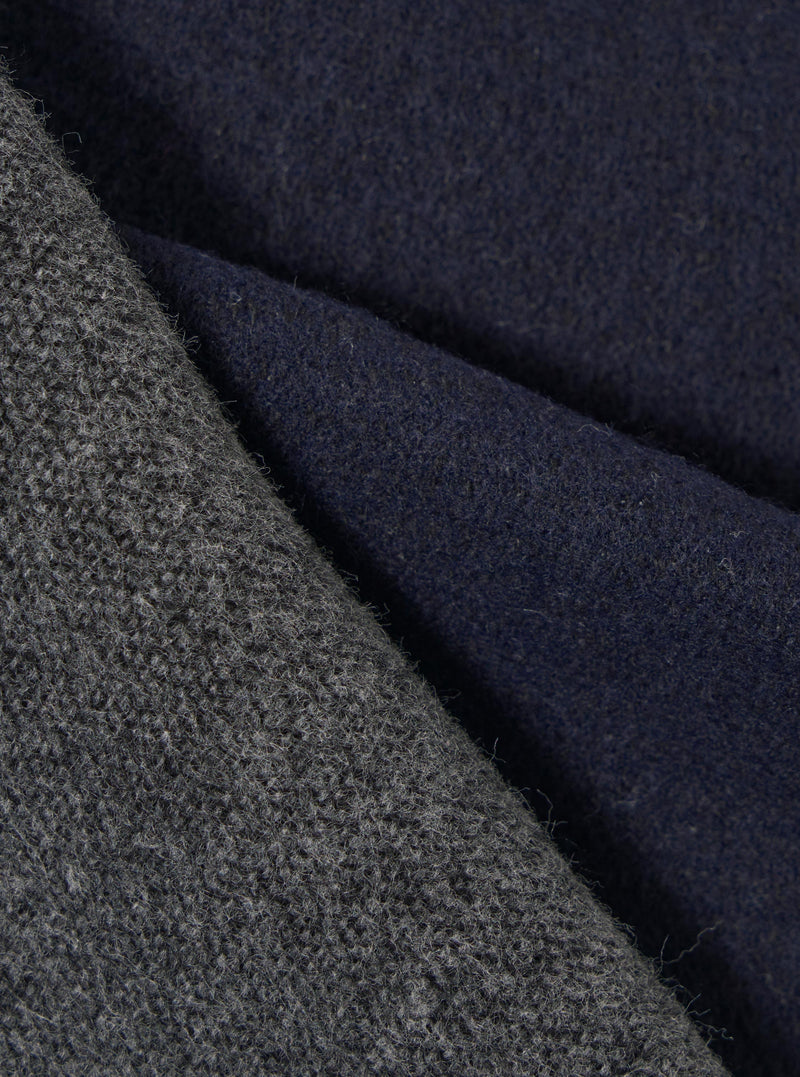 Close-up fabric swatch shot highlighting the texture of the Navy/Mid Grey Double Sided Scarf. The detailed image captures the fine weave of the navy blue and mid-grey threads, showcasing the soft quality of the scarf fabric.