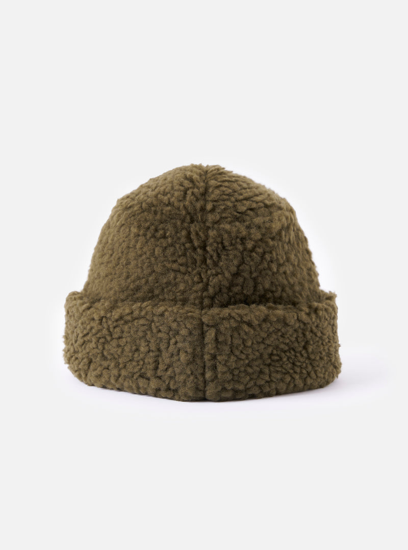 Close-up of the cableami® Olive Toque Boa Cap on a white background. The cap is olive green and made of a soft, boa-like material. The fit is snug and the cap has a slightly rounded shape.