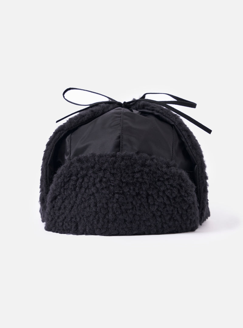 Close-up of the cableami® Black Military Nylon Twill Boa Aviator hat on a white background. The hat features black nylon and boa trim with tie strings.