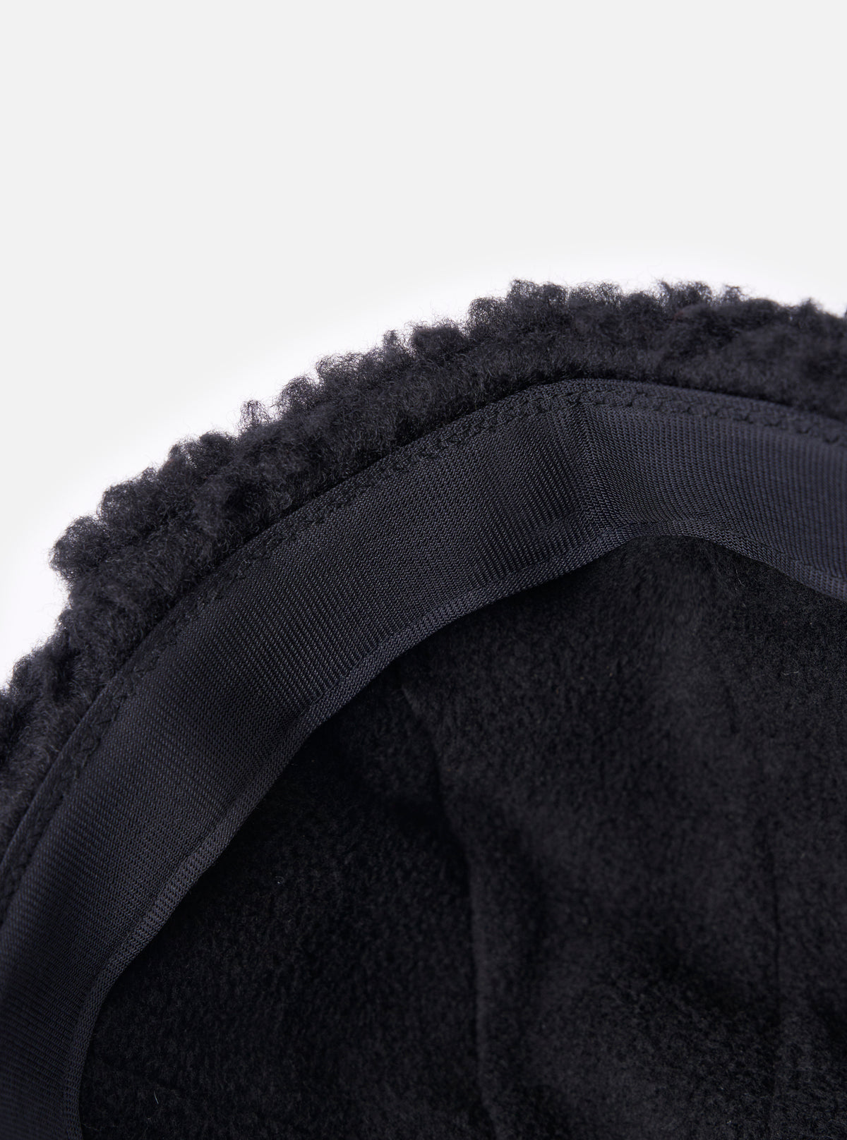 Close-up of the inside of the cableami® Black Military Nylon Twill Boa Aviator hat, showing the black boa trim and nylon twill lining against a white background.