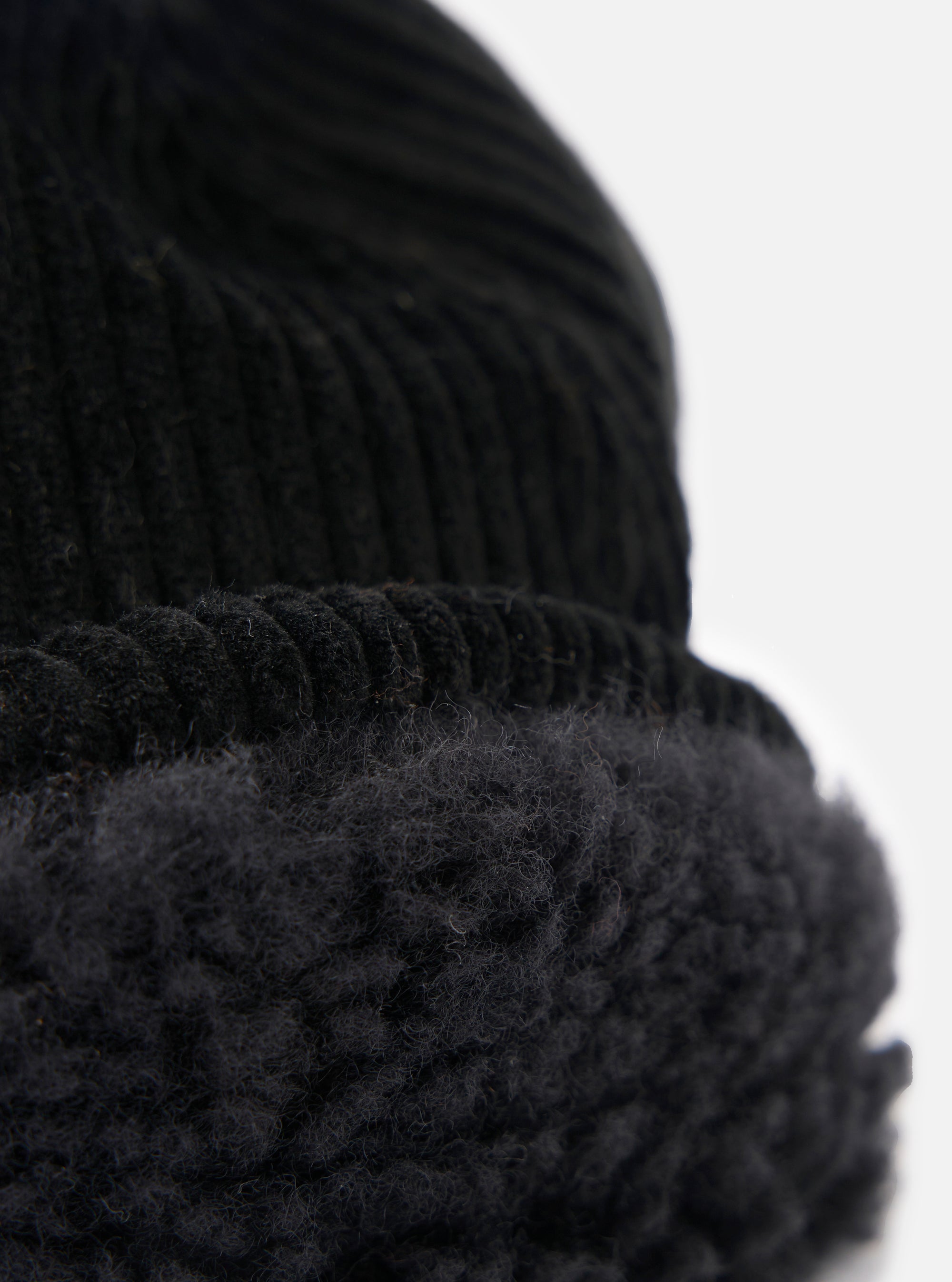 Close-up of the cableami® Black Corduroy 5w Cap showing the corduroy texture and soft lining against a white background.