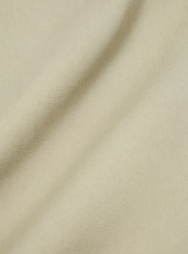 Close-up of the sand twill fabric used for the Fatigue Pant (Undarted). The texture and color are highlighted on a plain background.