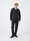 Full front view of a male model wearing the Black Twill London Jacket against a plain light studio backdrop, styled over a casual shirt to showcase the overall tailored fit and classic collar line.