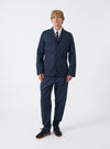Front view of a male model wearing the Navy Twill London Jacket standing against a neutral studio backdrop, showing how the jacket fits across the shoulders and chest in a full styled outfit look.