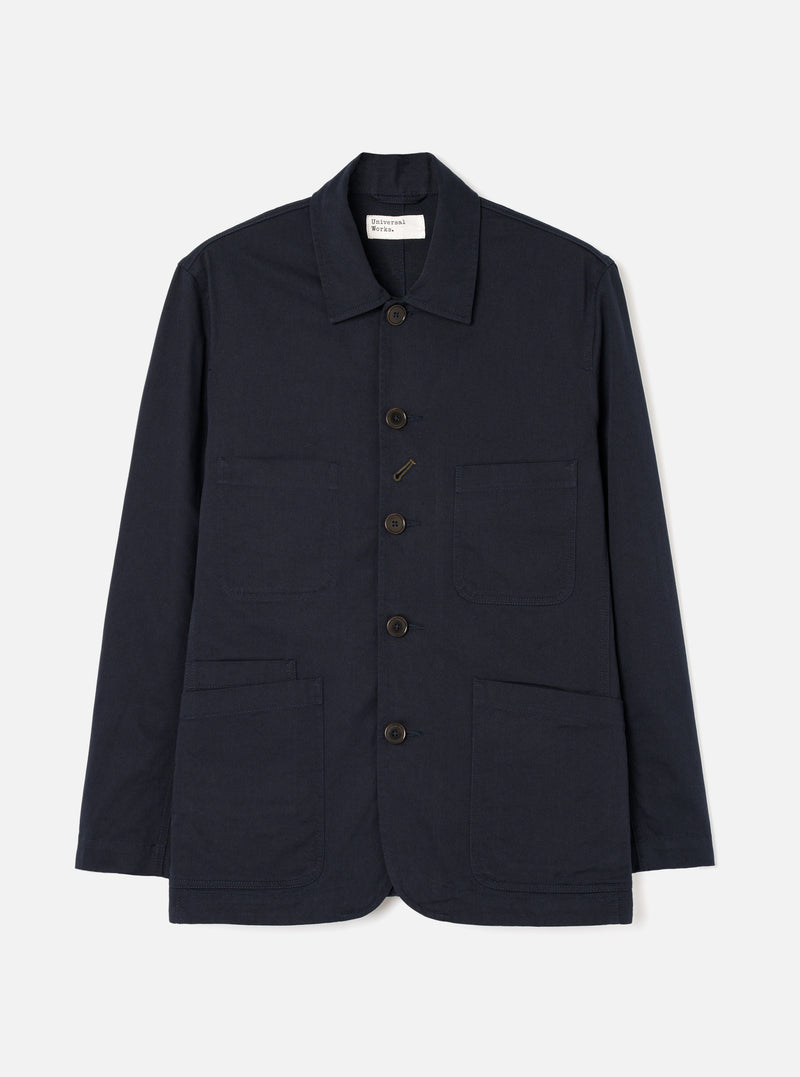 Front view of the Navy Twill Bakers Chore Jacket presented flat against a plain white background. Shows five button closures, chest patch pocket, and two front waist pockets in dark navy blue twill fabric.