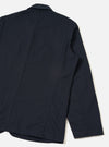 Back view of the Navy Twill Bakers Chore Jacket displayed against a plain white background. Highlights the clean dark navy twill cotton fabric, straight hemline, and simple seam detailing across the back.
