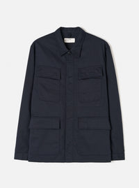 Front view of the Navy Twill MW Fatigue Jacket displayed against a white background. Shows four front flap pockets, hidden button placket, folded collar, and structured military-inspired utility style in navy.