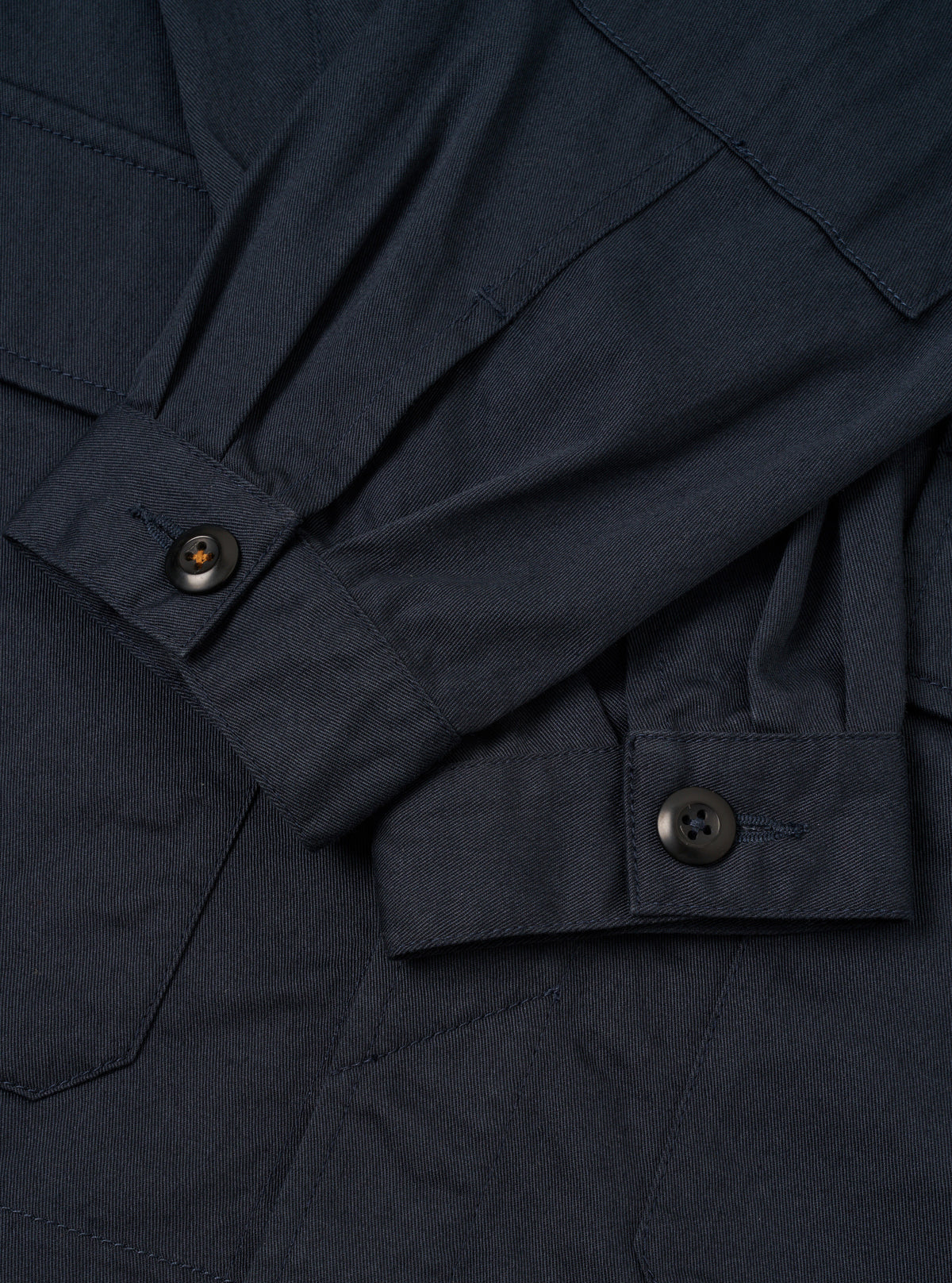 Internal view of the Navy Twill MW Fatigue Jacket against a white background. Shows the unlined cotton twill interior, waist drawstring adjustment channels, and internal pocket detail clearly.