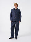 Full front shot of the Indigo 13oz Selvedge Denim Bakers Chore Jacket laid flat against a clean off-white background, highlighting button closures, patch pockets, and rich blue finish.