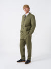 A model wearing the Light Olive Twill Three Button Jacket standing against a plain backdrop, featuring a front-facing view that highlights the tailored fit and olive green tone.