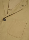 Front view of the Sand Twill Three Button Jacket displayed against a plain off-white background. Features three front buttons, notch lapels, structured chest, and front patch pockets.