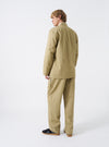 Rear studio view of a male model wearing the Sand Twill Kyoto Work Jacket against a plain background. Demonstrates the drop shoulder construction and relaxed drape of the jacket across the back.