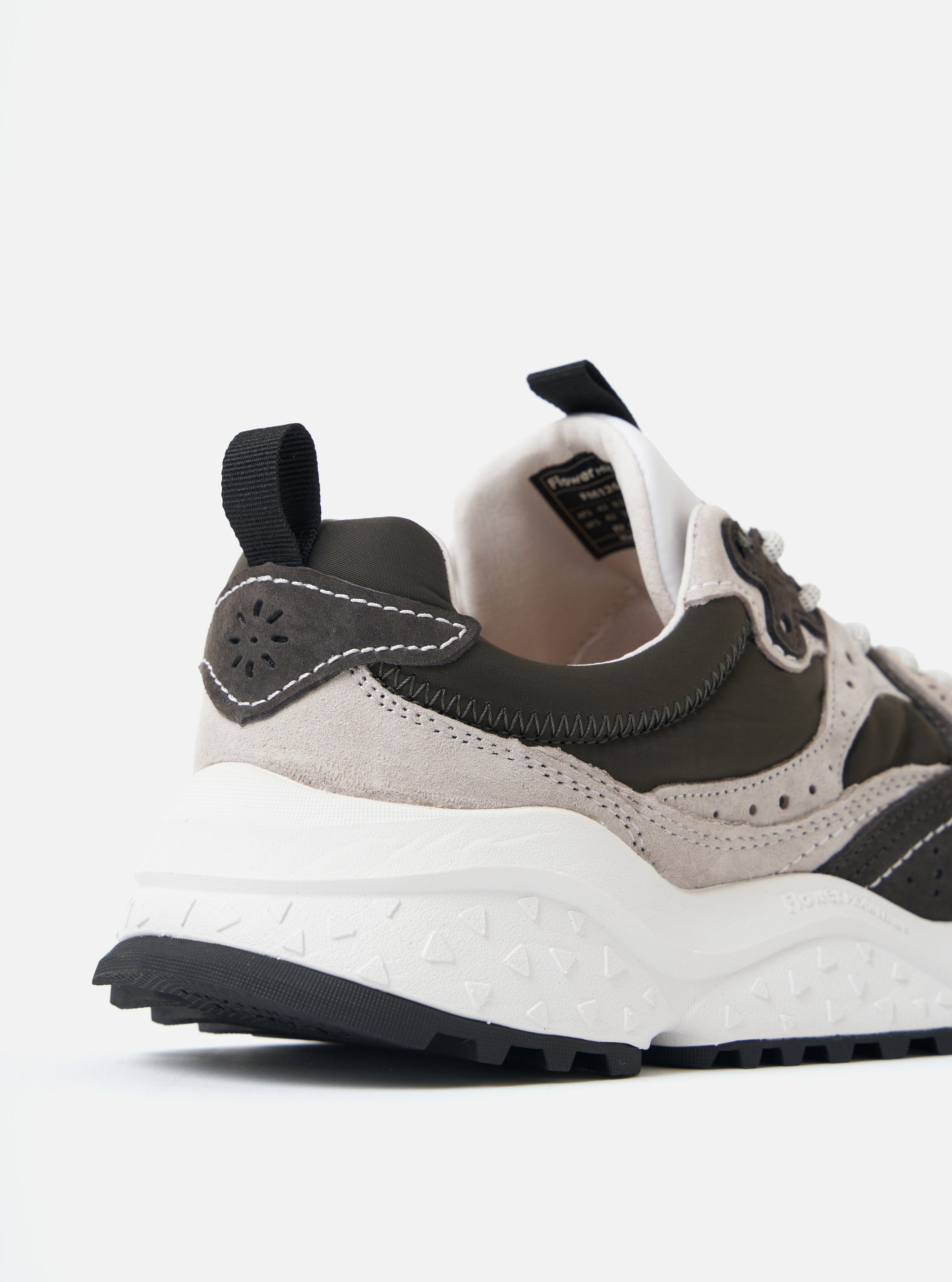 Close-up of the Flower Mountain Light Grey/Dark Grey Wave Man sneaker. Features suede, nylon, and a white sole. Shot on a white background.