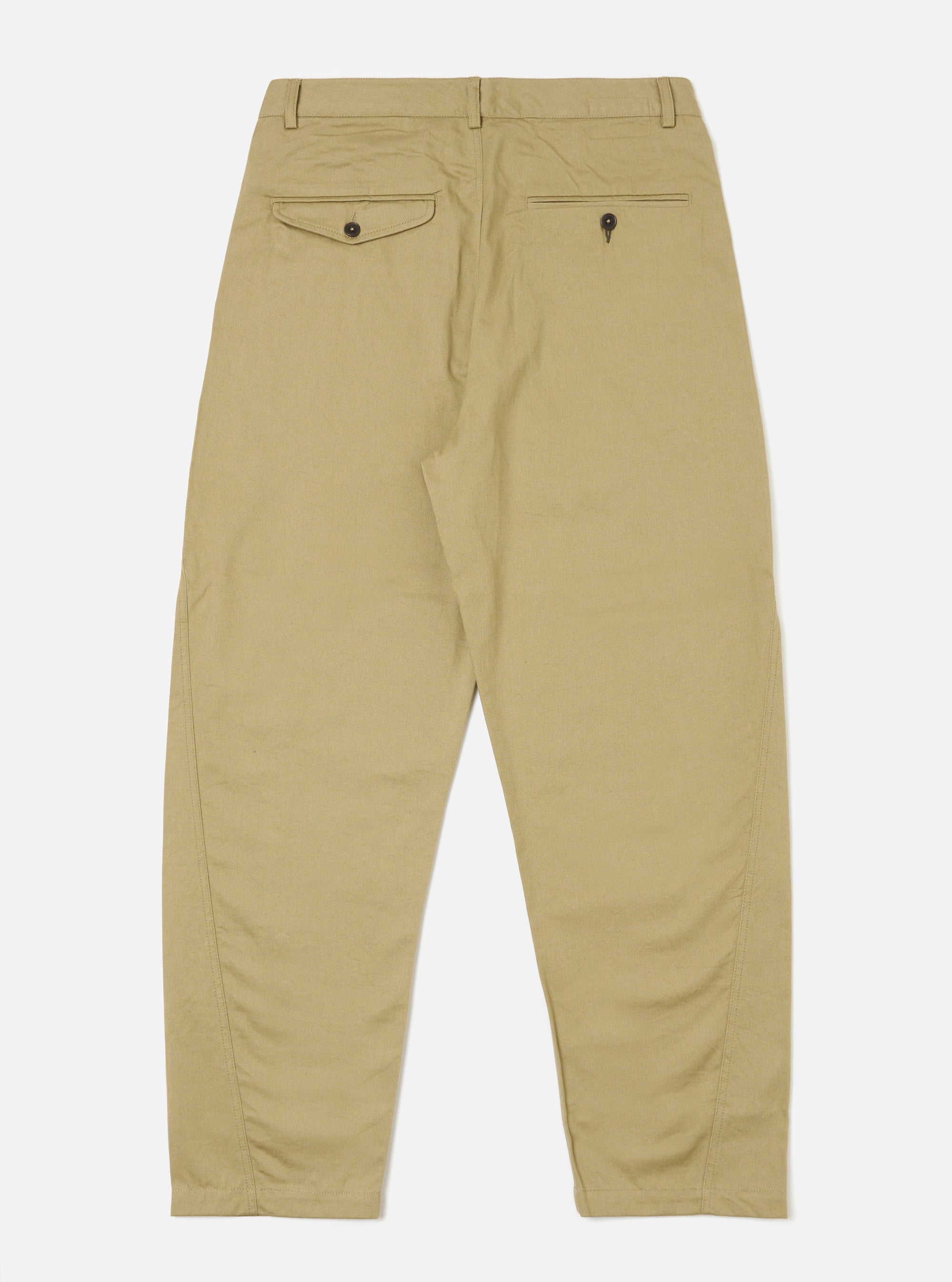 The Sand Twill Curved Pant in sand color, made of twill fabric, is laid out on a white background. The pants have a curved fit and visible back pockets.