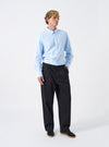 Front view of a model wearing the Navy Twill Duke Pant in a studio set with a plain off-white background. The model wears the navy trousers with shoes, highlighting the wide leg silhouette and neat front pleats.