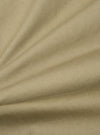 Close-up of the Sand Twill Aston Pant fabric. The twill weave is visible in the sand-colored material, draped on a flat surface.