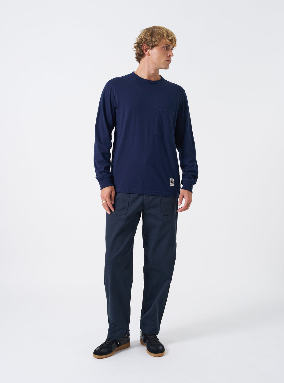 A model wearing the Navy Twill Fatigue Pant in a full front view against a plain background. The trousers are paired with casual footwear, demonstrating the straight fit and waist placement on the model.