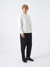 A model wears the Black Twill Hi Water Trouser against a white background. The front view highlights the elasticated drawstring waist, relaxed fit around the hips, tapered leg silhouette, and cropped ankle length.
