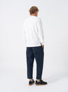 Rear shot of a model wearing the Navy Twill Hi Water Trouser against a plain white background. Shows the rear patch pockets, comfortable gathered waistband, straight loose thigh, and cropped hem length above the shoes.