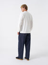 Rear view of the Indigo 13oz Selvedge Denim Duke Pant shown against a plain white studio backdrop. Features two spacious back patch pockets, clean waistband stitching, structured back yoke, and wide tapered legs.