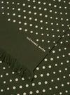 Close-up of the Olive Dot Print Short Scarf, featuring an olive green fabric with white polka dots and fringed edge. The words 'universal works.' are printed on the scarf.