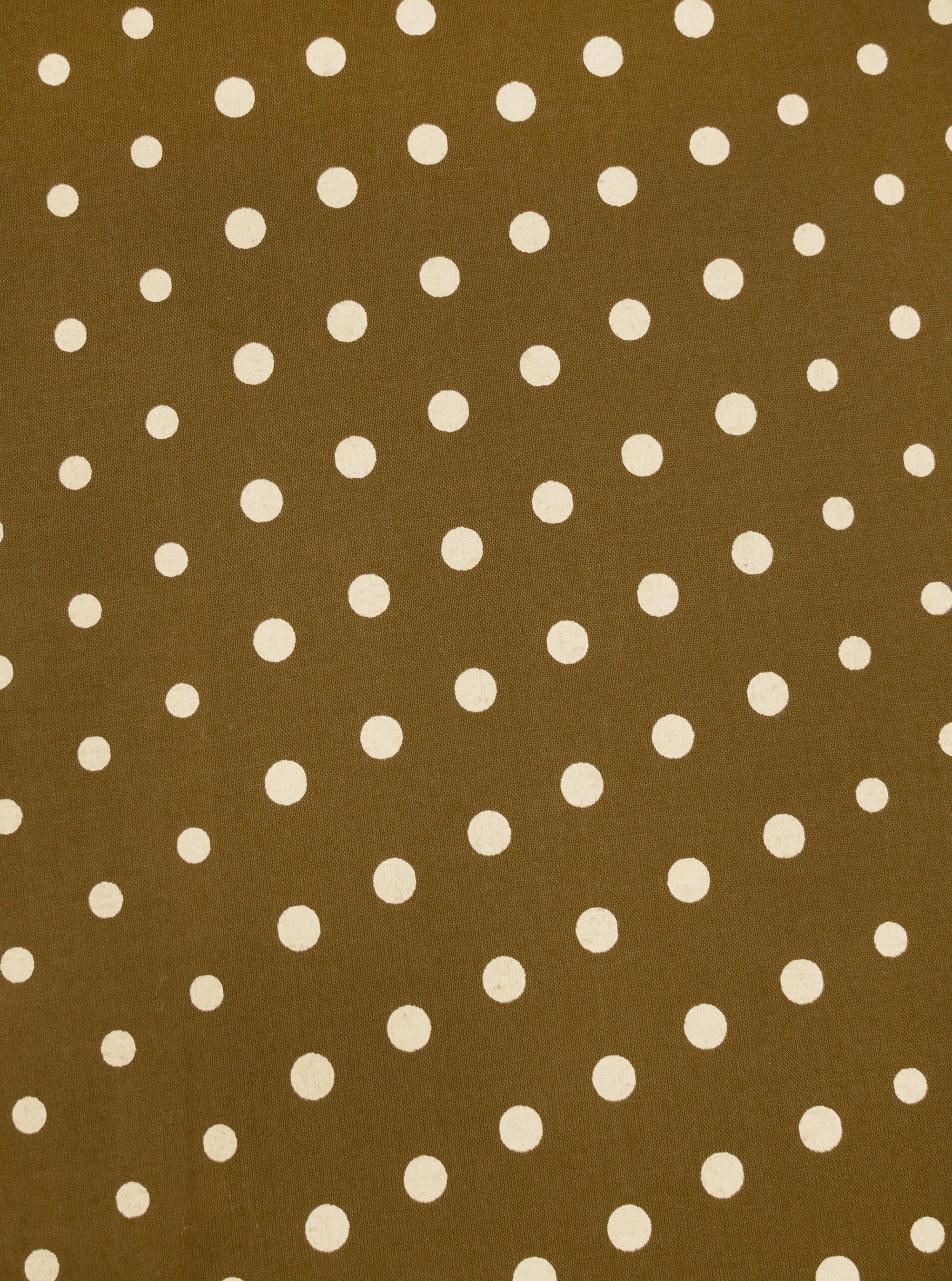 Close-up of a Mustard Dot Print Short Scarf. The scarf has a mustard background with white polka dots. The fabric is flat and evenly lit.