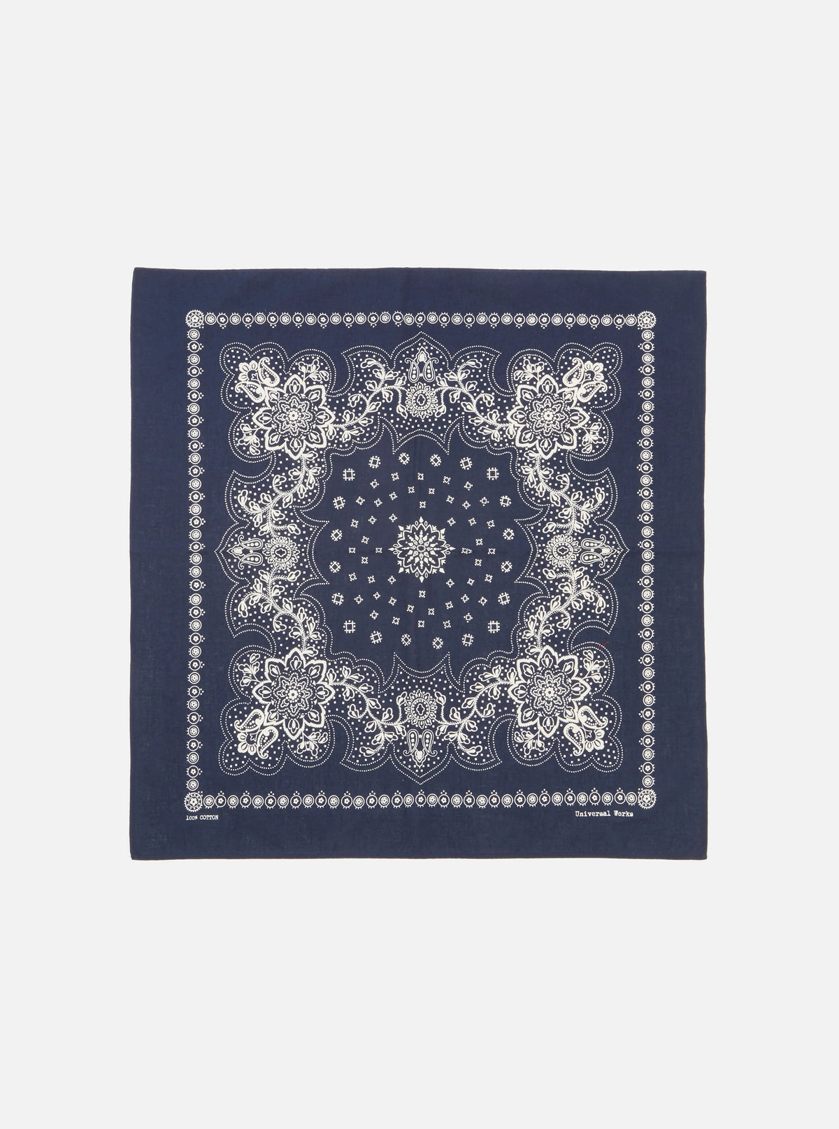 Flat lay of a Navy Classic Bandana Neckerchief on a white background. The bandana is navy with a white floral pattern. 100% cotton.