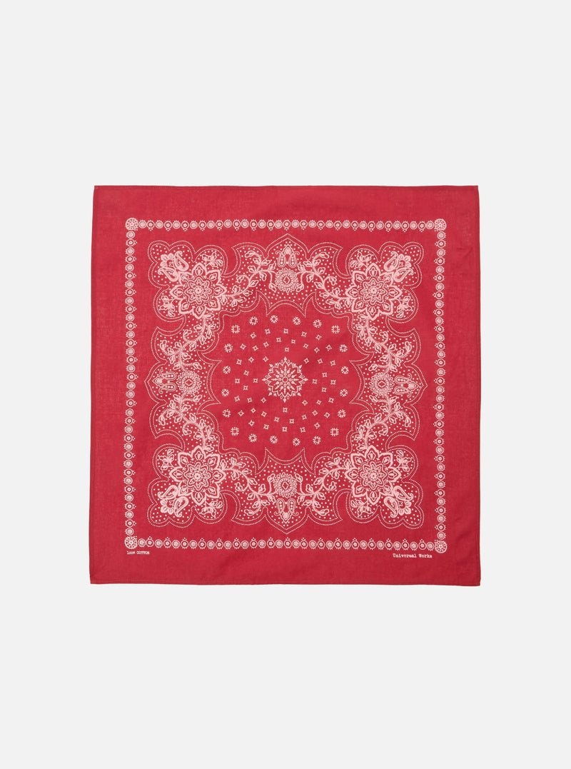 The Red Classic Bandana Neckerchief, a square of red cotton with a white paisley pattern, is displayed on a white background.