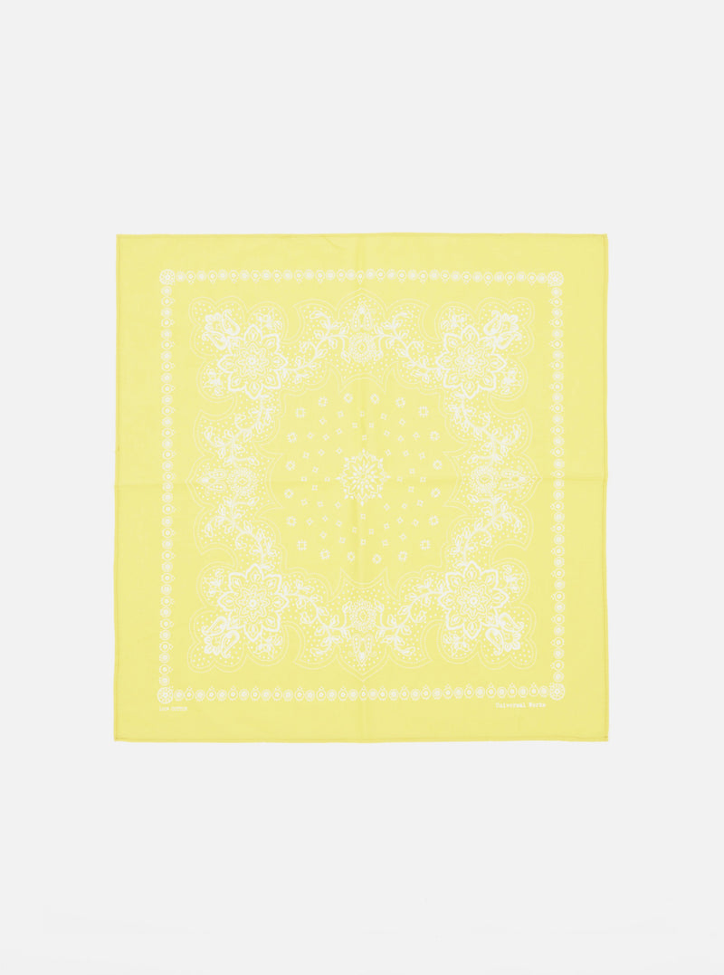 Laid flat on a white surface, this Yellow Classic Bandana Neckerchief features a white floral paisley print. Versatile accessory for a pop of color.