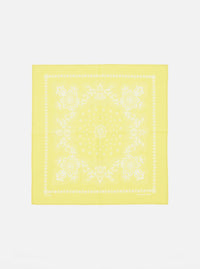 Laid flat on a white surface, this Yellow Classic Bandana Neckerchief features a white floral paisley print. Versatile accessory for a pop of color.