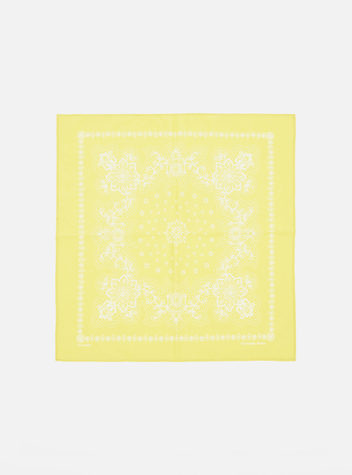 Laid flat on a white surface, this Yellow Classic Bandana Neckerchief features a white floral paisley print. Versatile accessory for a pop of color.