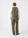 A model wears the Light Olive Twill Field Waistcoat against a clean neutral studio background. The side perspective highlights the structured profile, comfortable layering cut, light olive cotton twill material, and neat pocket stitching.