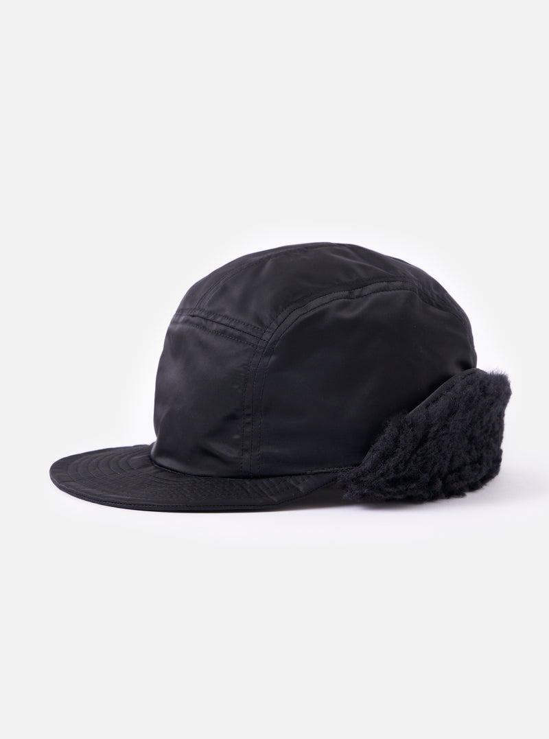 Side view of the cableami® Black Military Nylon Twill Cap on a white background. The cap is black nylon with ear flaps.
