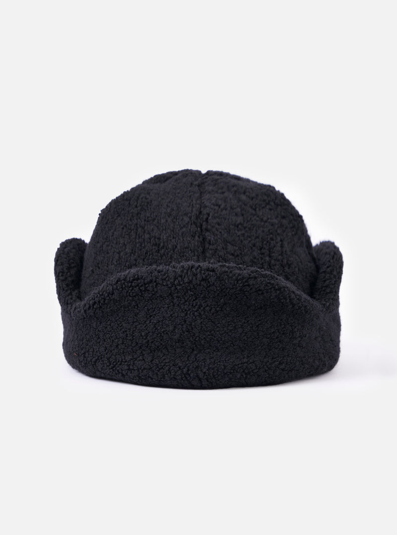 Close-up of the cableami® Black Recycled Wool Flight Watch Cap on a white background. The cap is made of black, textured wool and has a rounded shape.