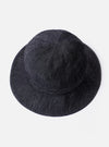 The cableami Black 10oz Denim Metro Hat is shown from a rear angle as a flat lay against a plain white background. The image highlights the rounded crown construction and the downward-sloping brim of the black denim fabric. A black adjustable drawcord with a plastic toggle and a detachable strap are visible.