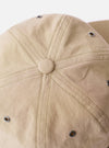 The cableami Beige/Olive Cotton/Nylon B.B Cap is shown from a rear three-quarter angle as a flat lay against a plain white background. The image highlights the adjustable leather strap with a metal buckle and the dual-tone construction, featuring a beige crown and an olive green brim.