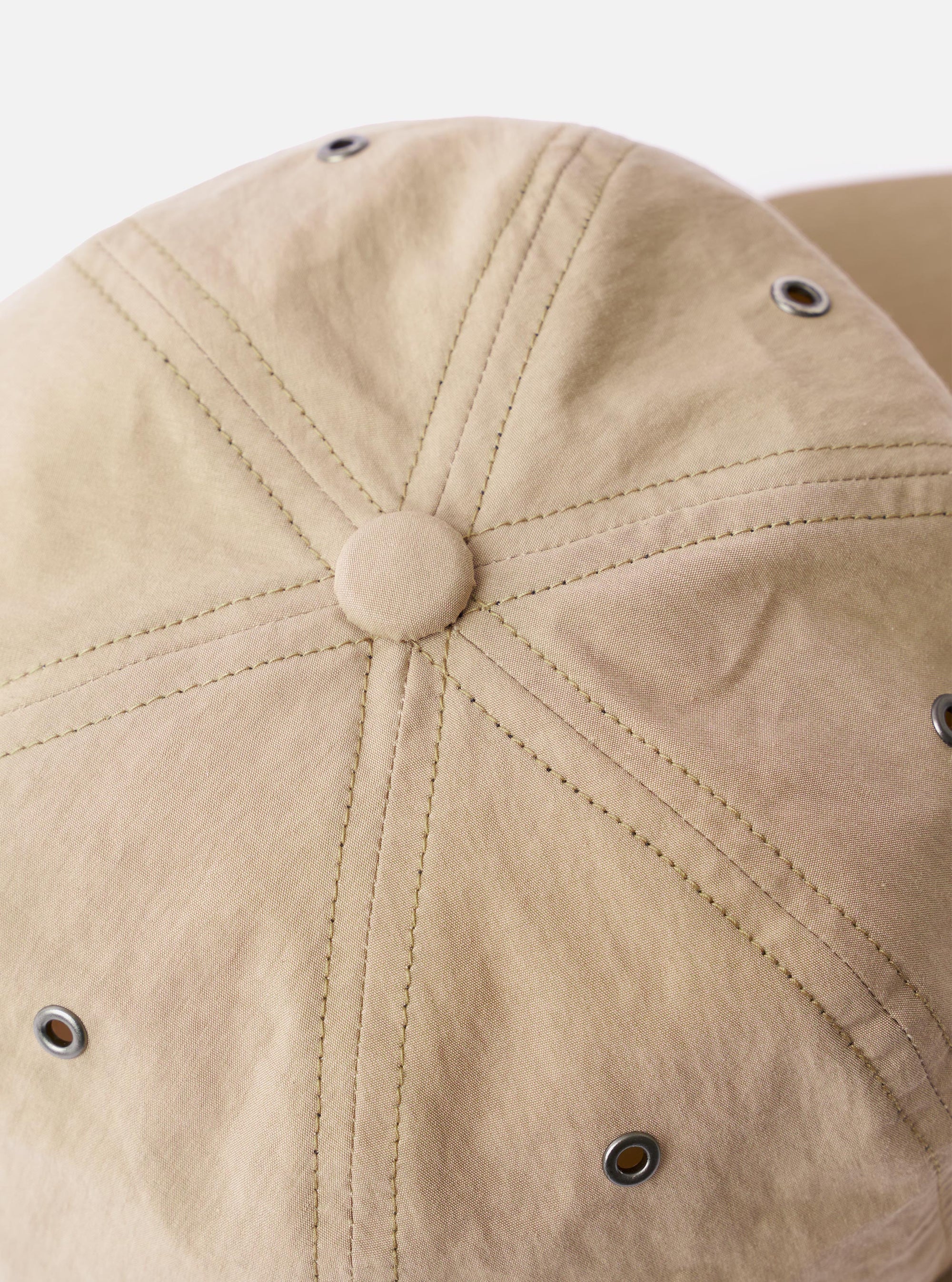 The cableami Beige/Olive Cotton/Nylon B.B Cap is shown from a rear three-quarter angle as a flat lay against a plain white background. The image highlights the adjustable leather strap with a metal buckle and the dual-tone construction, featuring a beige crown and an olive green brim.