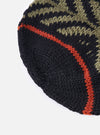Close-up of a cableami® Black Wool Jacquard Watch Cap on a white background. The cap features a black base with olive and orange jacquard patterns.