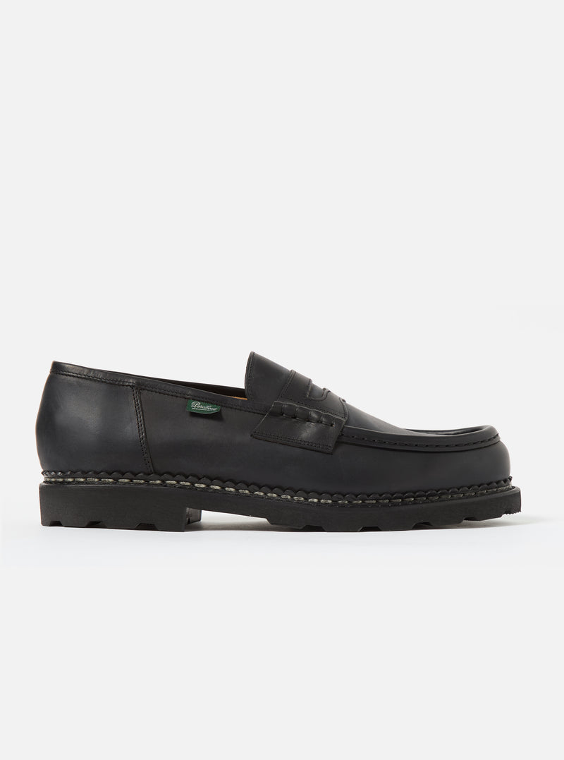 Studio shot of a Paraboot Black Leather Reims Marche shoe. The black leather loafer has a thick sole. Clean white background.