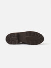 Underside of the Paraboot Reims Marche in cafe leather, showing the dark brown chunky rubber outsole. Deep directional lugs run around the heel and forefoot, with a ribbed central zone and embossed Paraboot branding on the shank. Shot on a plain light grey studio backdrop.