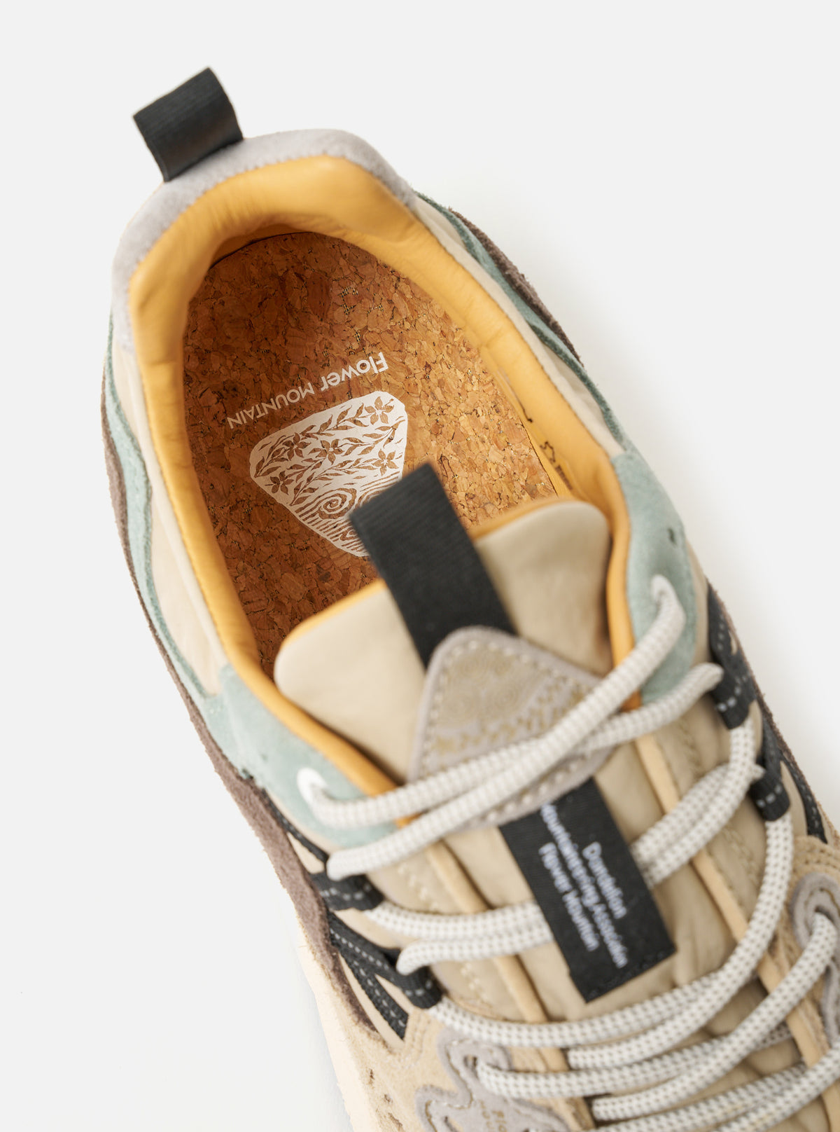 Sole view of the Flower Mountain Sand/Beige/Taupe Cow Velour Yamano 3 Uni sneaker against a plain neutral background. Prominently displays the durable rubber outsole pattern, aggressive lug design, and debossed brand logo details on the bottom.