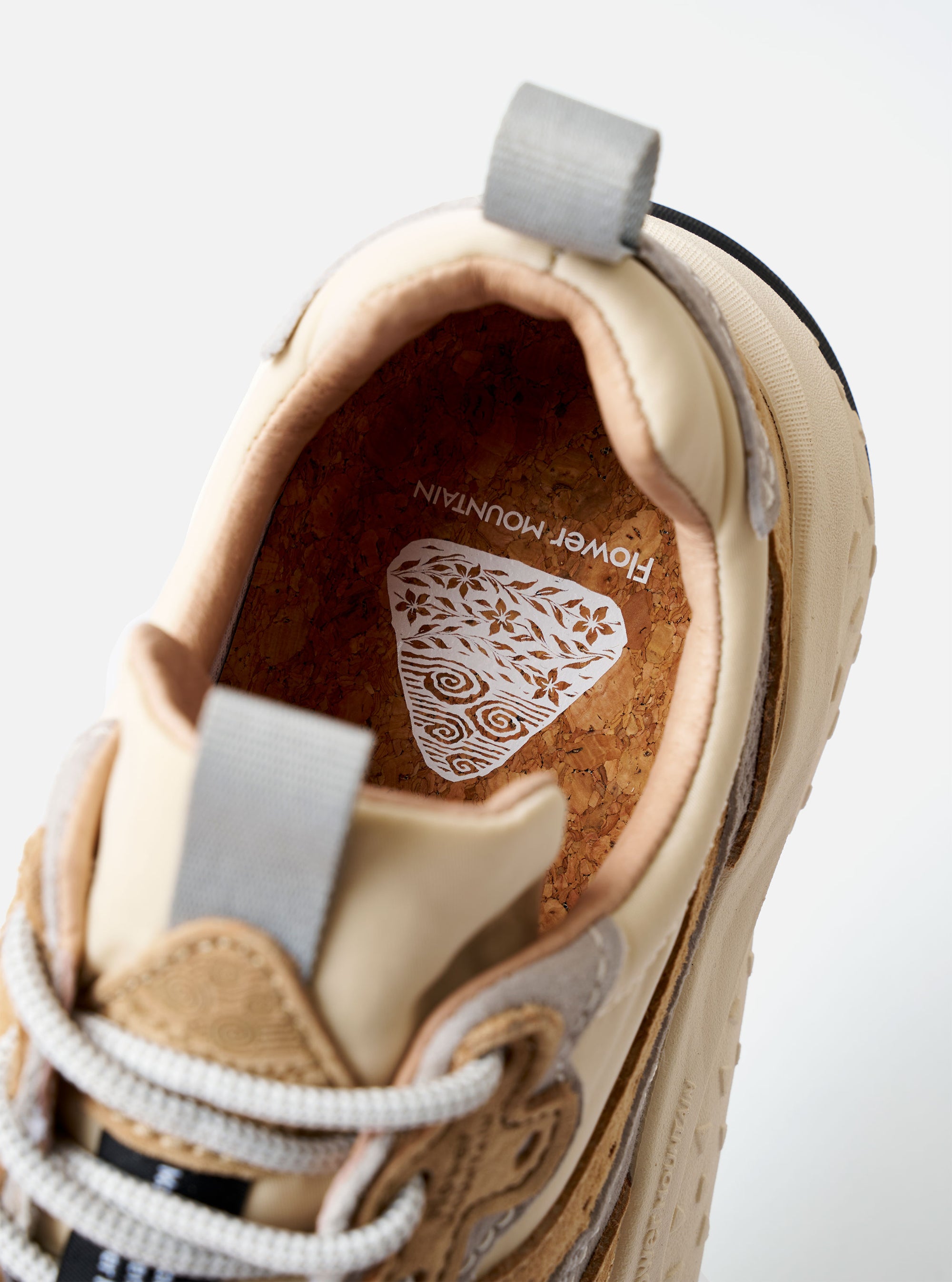 The Flower Mountain Beige, Cream, and Light Grey Suede and Nylon Wave Uni sneaker is shown from a side profile view against a plain white background. The shoe features a technical ripstop nylon upper with overlapping suede overlays in beige and light grey, trekking-style laces with unique flower-shaped eyelets, and a prominent notched rubber sole with a two-tone tread.