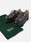 The Paraboot Black Leather Clusaz Jannu is shown in a studio shot against a plain white background. The low-top mountaineering shoe is crafted from smooth black leather and features metal D-ring eyelets with black rope laces. The design is characterized by a prominent Norwegian welt with visible stitching and a thick, rugged black rubber lug sole.