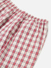 Close-up of the Red Cotton Check Pyjama Pant on a white surface. The red and white checkered pattern is visible, showcasing the soft cotton material and comfortable fit.