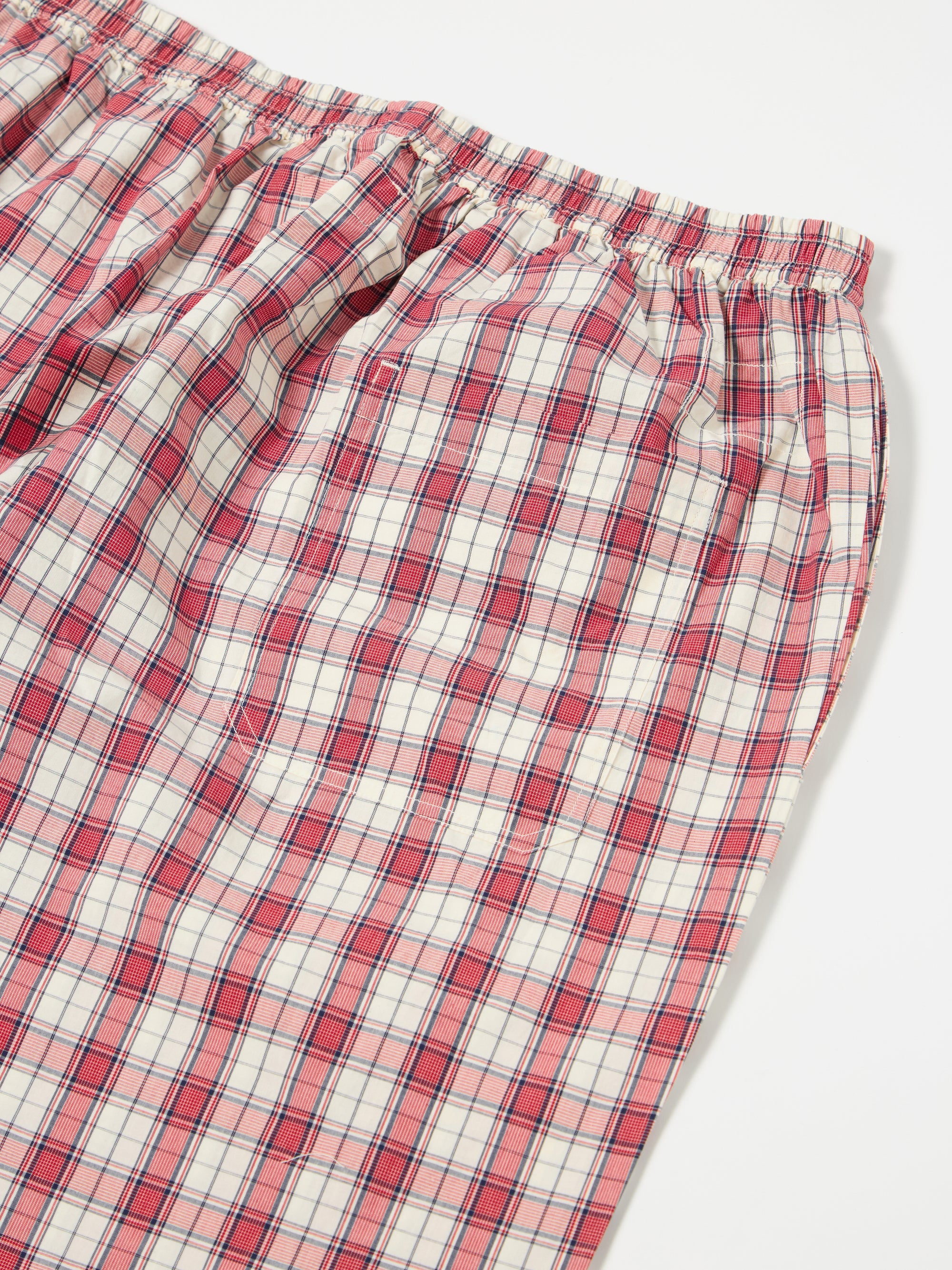 Close-up of the Red Cotton Check Pyjama Short on a white surface. The red and white plaid pattern is visible, showcasing the soft cotton material and comfortable fit.