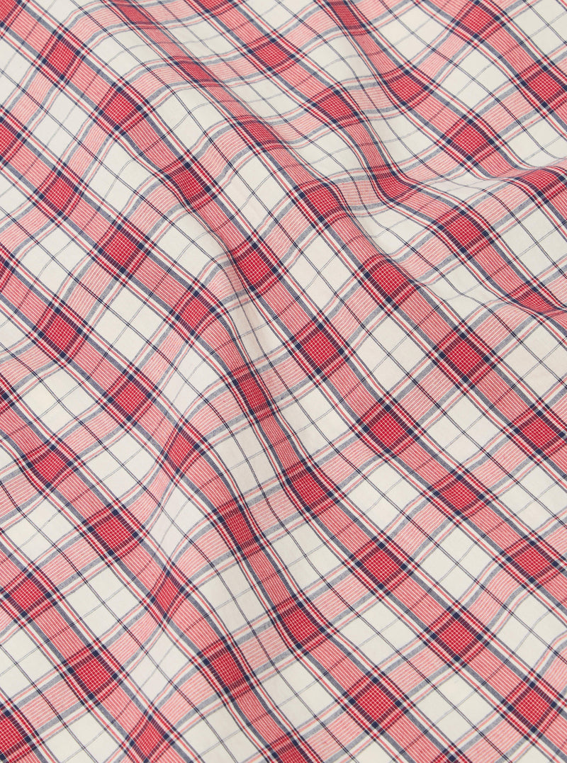 Close-up of the Red Cotton Check Pyjama Short fabric. The red and blue plaid cotton is softly draped on a flat surface.