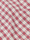 Close-up of the Red Cotton Check Pyjama Short fabric. The red and blue plaid cotton is softly draped on a flat surface.