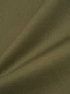 Close-up of the light olive twill fabric used for the Field Waistcoat. The material is draped to show texture and color. 